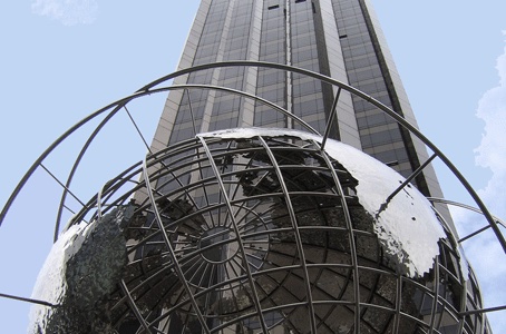 Large globe set against tall skyscraper