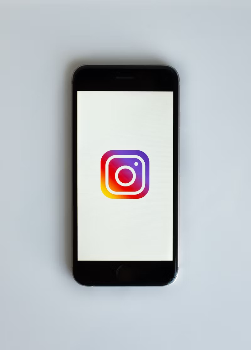Phone screen displaying the Instagram logo.