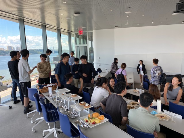 A group of MSFE students gather around food on their first day