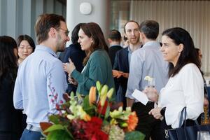 photo of faculty mingling at a new faculty reception event
