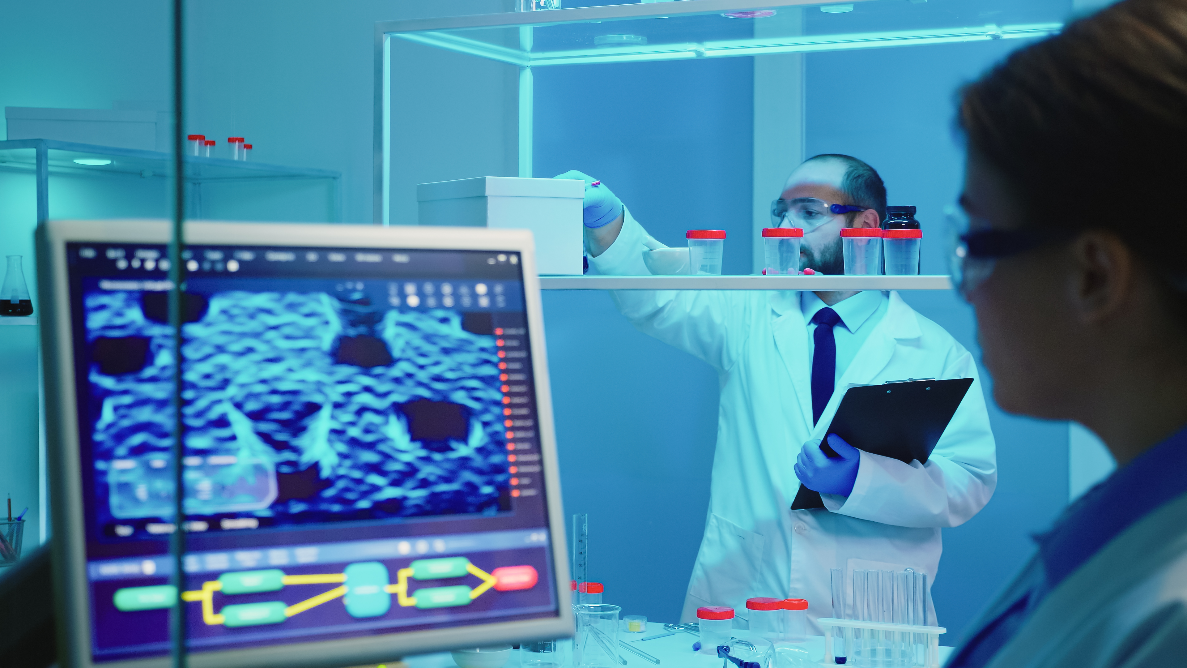 man chemist checking bottle pills chemistry tools working late medical researching