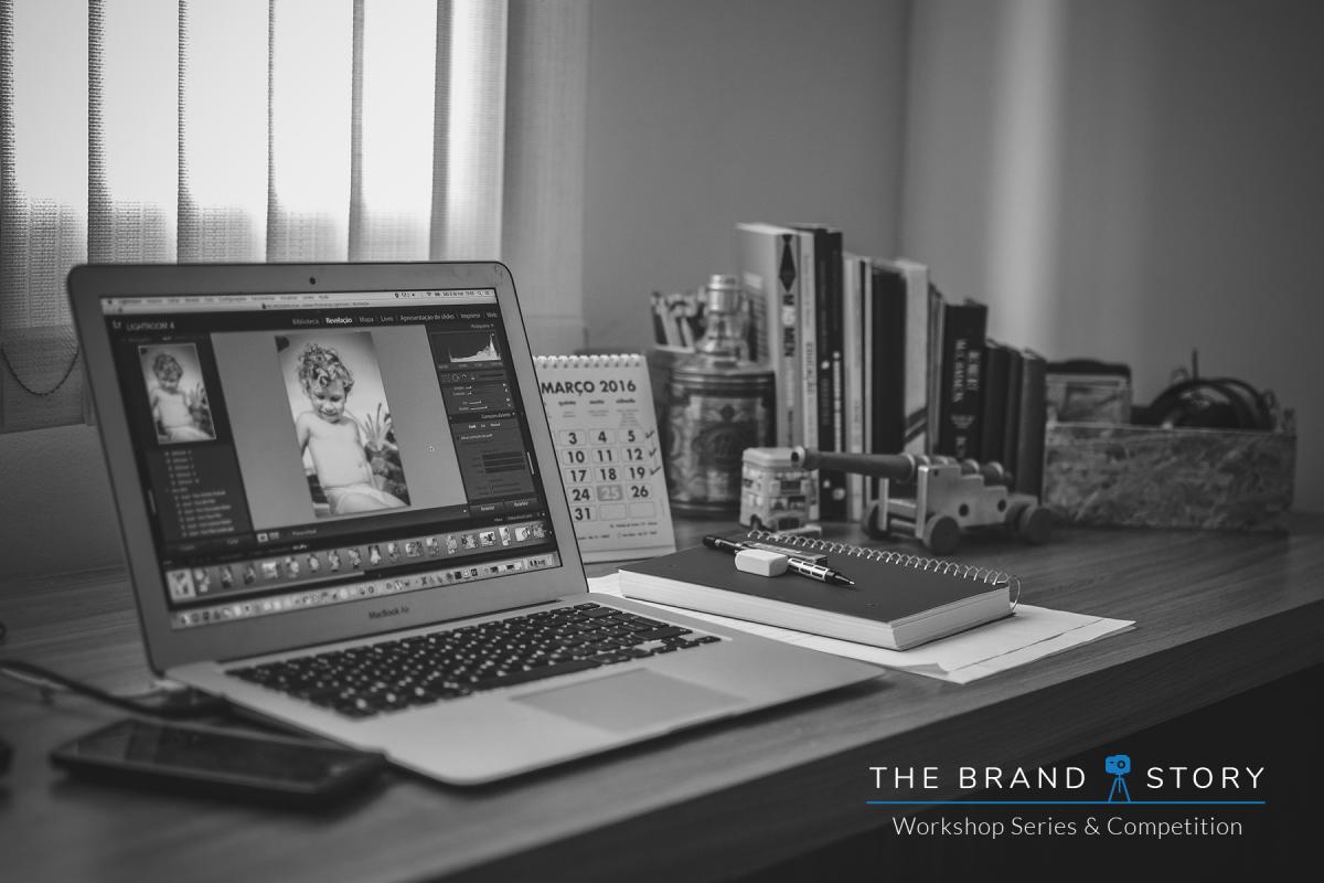 Moody black and white photo of a laptop open on a desk