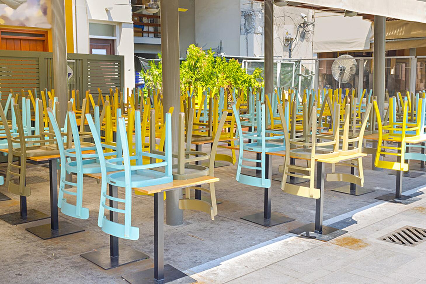 A closed business with chairs upside down on tables