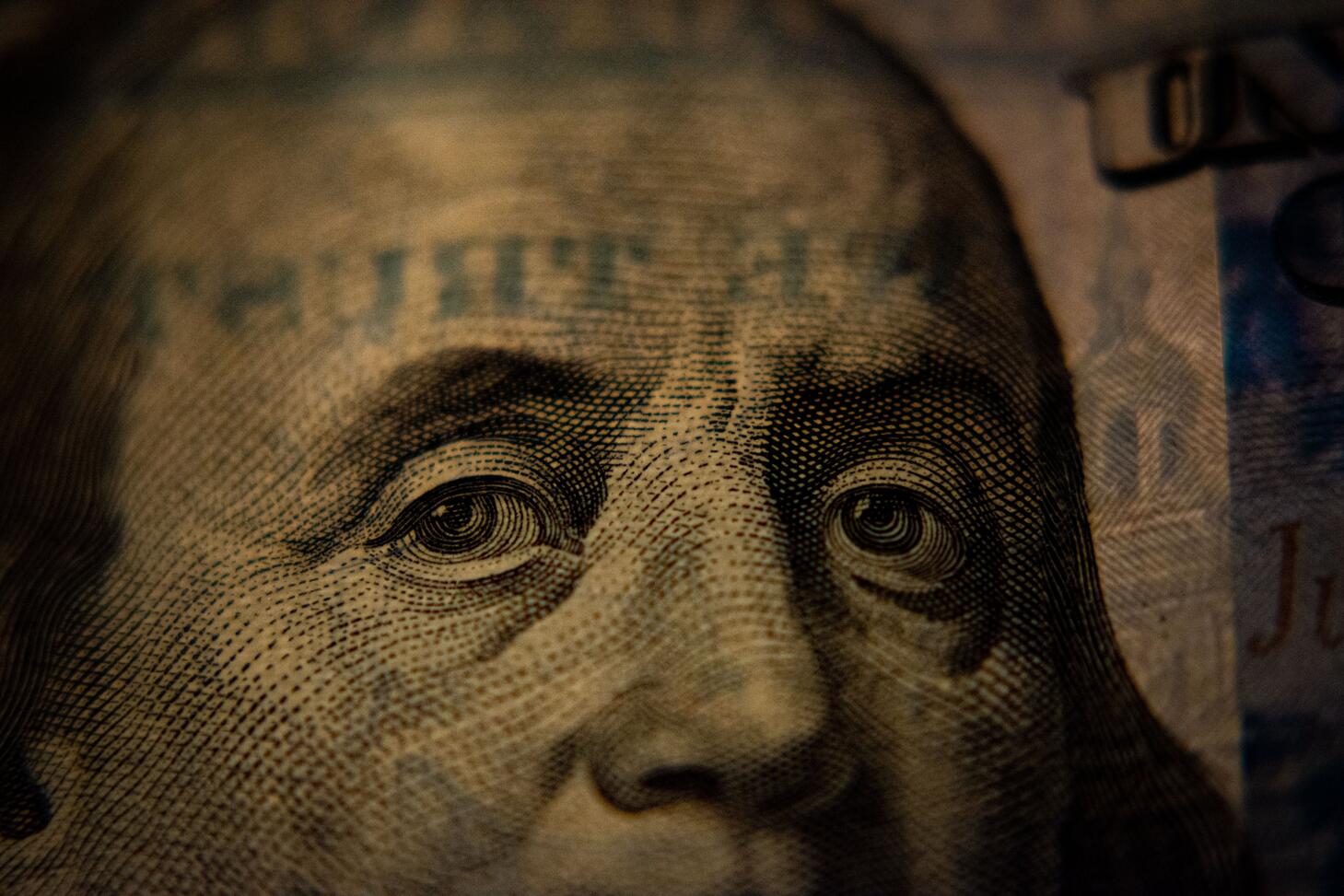 A closeup of a US hundred dollar bill (Benjamin Franklin side). Photo by Adam Nir on Unsplash.