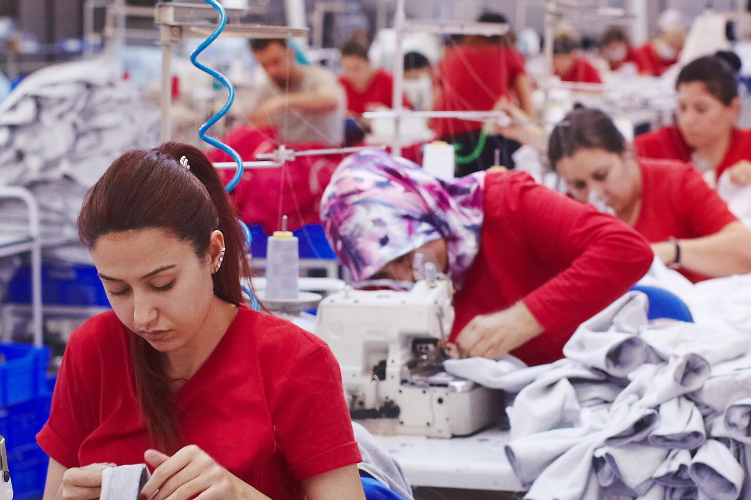 Women working in a factory sewing clothing.