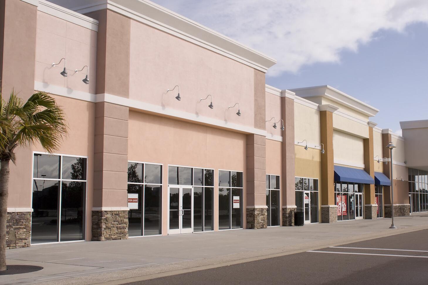 A strip mall of several retail stores.