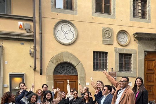 students pointing at a three circle model in Florence