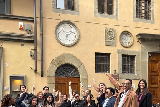 students pointing at a three circle model in Florence