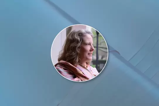 Headshot of Patricia Angus on a blue background 