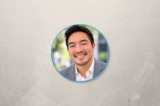 Headshot of Christopher Poon on a grey backdrop 