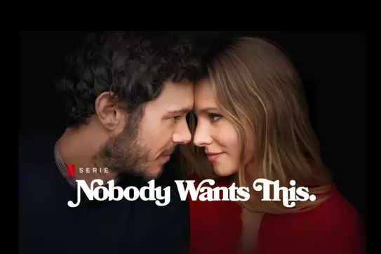 Nobody Wants This," featuring Kristen Bell and Adam Brody standing side by side in formal attire, with a tense family gathering in the background