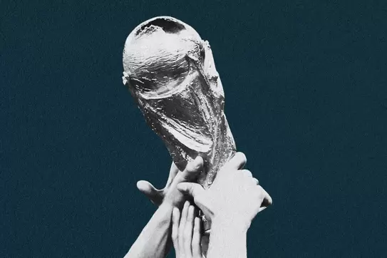 Hands holding the World Cup trophy.