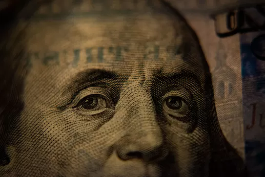 A closeup of a US hundred dollar bill (Benjamin Franklin side). Photo by Adam Nir on Unsplash.