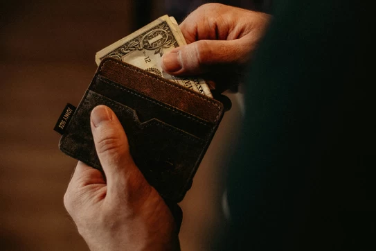 taking dollar bill out of wallet