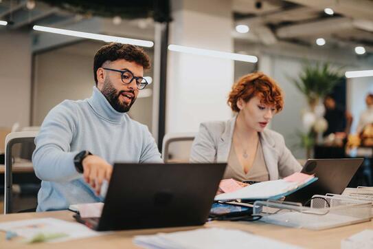 Diverse business team collaborating on marketing strategies in a modern office.