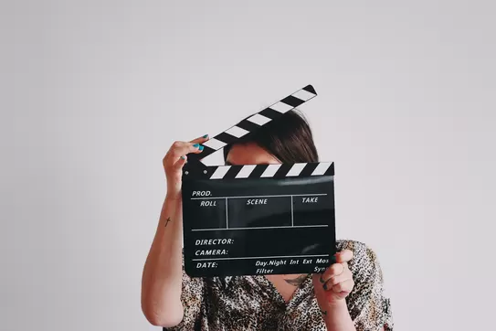 person holding a clapperboard