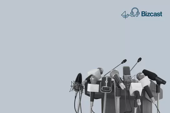 An empty podium surrounded by many microphones