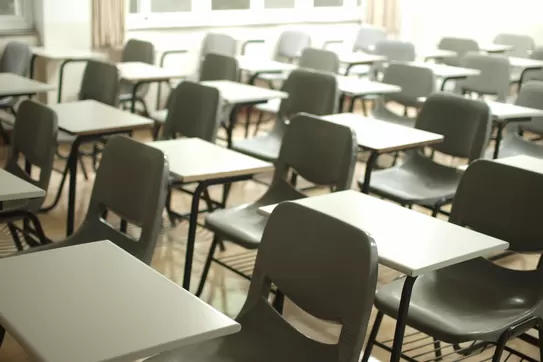classroom with rows of desks and chairs