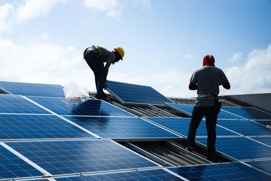 Workers installing solar panels