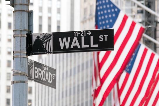 Wall Street sign and US flags