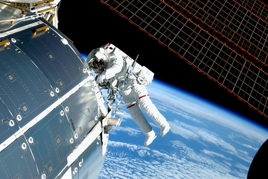 Astronaut in space, at the ISS, repairs and makes experiments. 