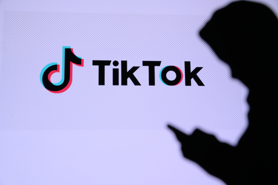 TikTok, Chinese video-sharing social networking service, with company logo on screen in background
