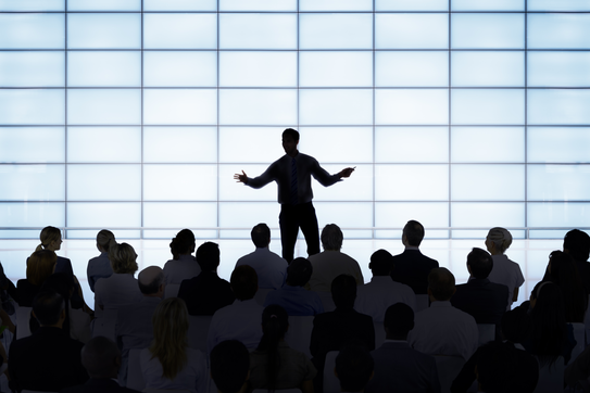 A business leader speaking before a crowd