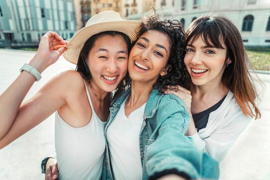 Three people take a selfie