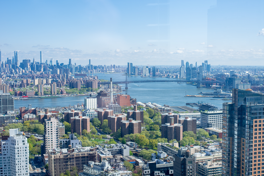 Aerial view of Manhattan and the Williamsburg Bridge from a Brooklyn rooftop