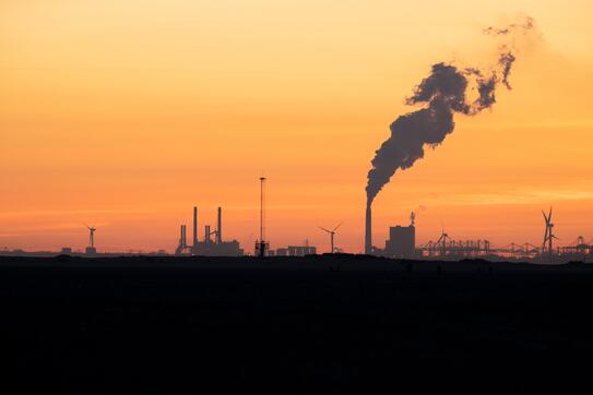 An industrial plant with a smokestack 