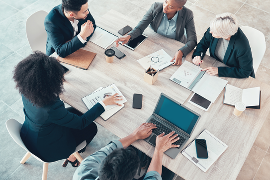 People speaking at a meeting.