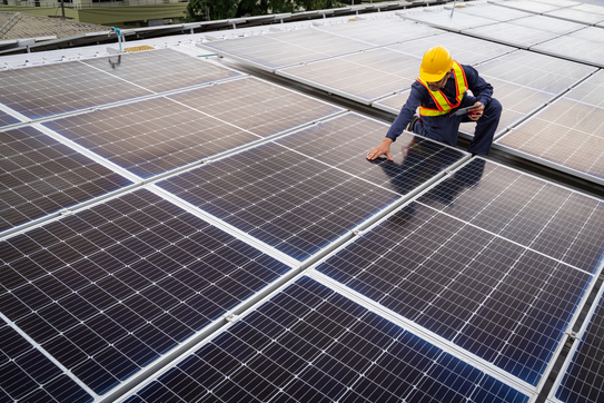 An engineer inspecting solar panels