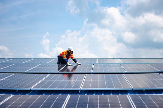 A worker installing solar panels