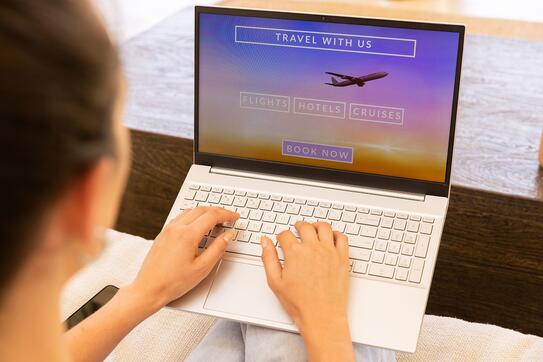 Booking travel online, woman using laptop for flights, hotels, and cruises. online booking, vacation, tourism, internet, leisure, holiday