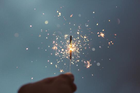 a hand holding a sparkler