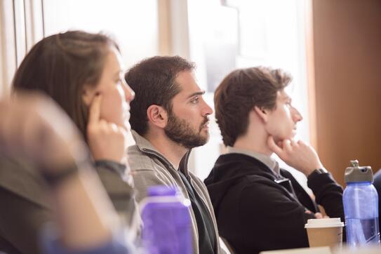 students in a classroom listening to a professor speaking