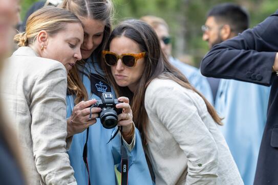 Photo of graduate with camera