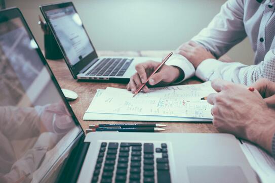 Person holding pencil near laptop computer photo – Free Work Image on Unsplash by Scott Graham.