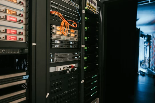 A rack of servers in a server room photo. Photo by Kevin Ache on Unsplash.com