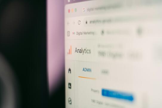 A very close-up view of the corner of a computer screen, one word viewable: "Analytics"