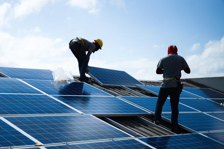Workers installing solar panels