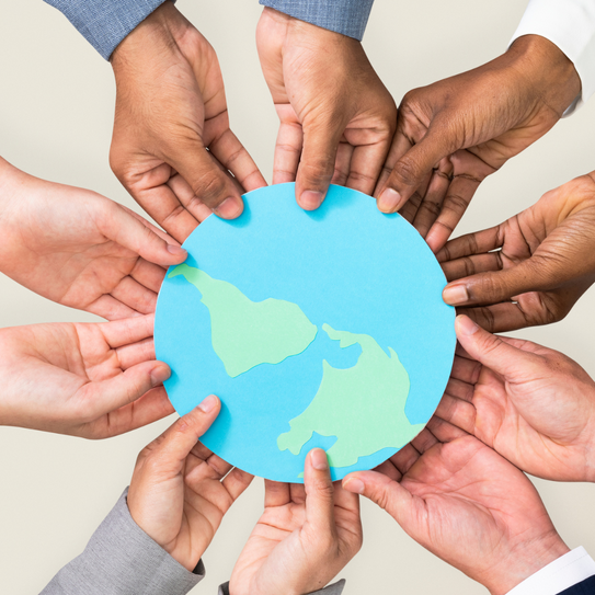 Image of many people holding a paper globe