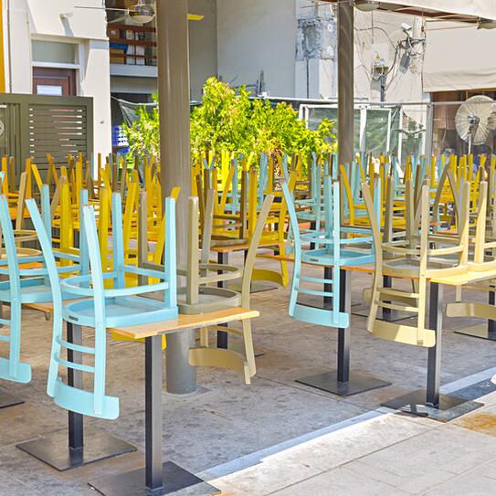 A closed business with chairs upside down on tables