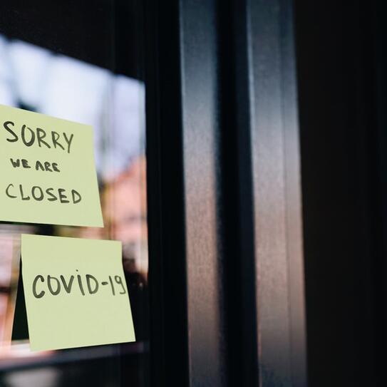 Closed signs on business windows