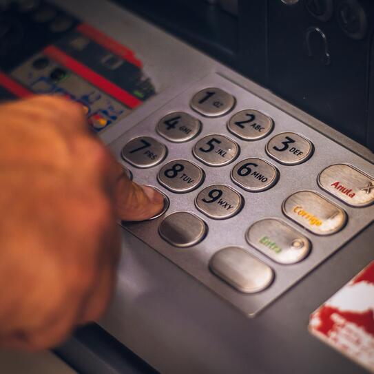 Using a ATM - Hand pressing number
