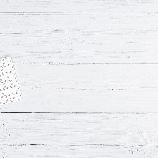 A white keyboard sitting on a white tabletop. Photo by iMattSmart on Unsplash