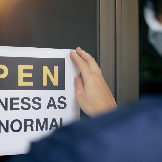 Sign on a business stating Open Business As New Normal 
